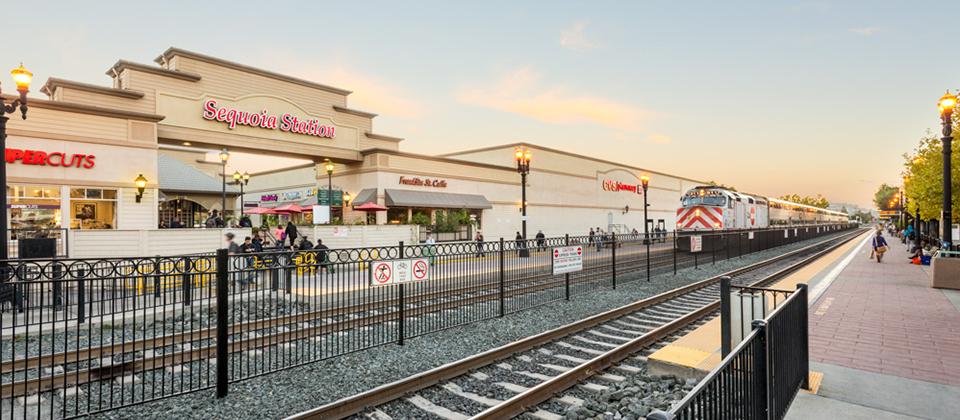 A View of Train Tracks Adjacent to a Shopping Center