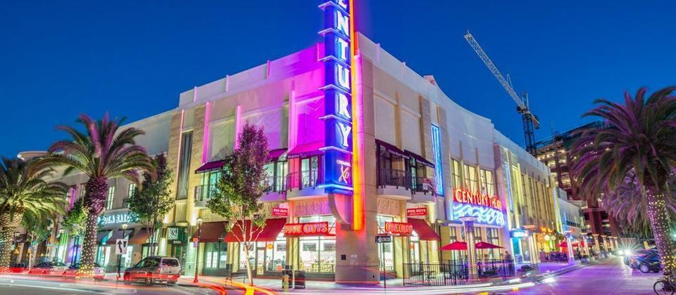 A Brightly Lit Neon Sign Illuminates the Front of a Building