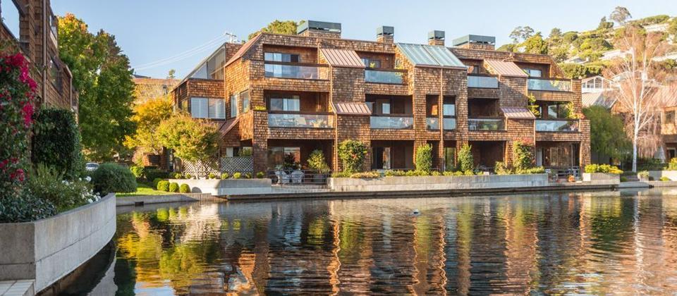 A Building Encircled by Water and Lush Trees